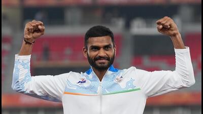Silver medalist India's Sarvesh Kushare Anil celebrates during the medal ceremony of the men's high jump final at the Asian Games in Nagoya, Japan, Sunday. (AP Photo/Mark Baker)