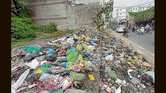 A view of damaged roads, garbage dump lying on the parks and road side in ward number 2. (Gurpreet Singh/Hindustan Times)