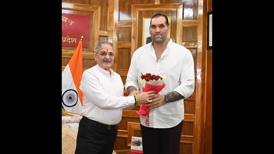 Former WWE wrestler Khali with Himachal Pradesh governor Kavinder Gupta at Lok Bhavan in Shimla on Sunday. (Deepak Sansta)
