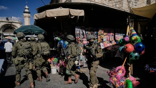 Israeli soldiers take positions during a military operation at a market in Nablus, West Bank, Sunday, Sept. 27, 2026.