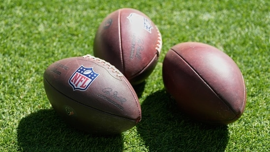 Footballs are shown before an NFL football game, Sunday, Sept. 27.