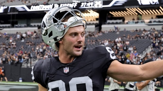 Brock Bowers of the Las Vegas Raiders waves to fans after warming up before a preseason game against the Arizona Cardinals at Allegiant Stadium on August 13.