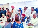 BJP national president Nitin Nabin (sitting third from left), party national general secretary Tarun Chugh, state unit chief Kewal Singh Dhillon, his predecessor Sunil Jakhar, and Rajya Sabha member Raghav Chadha interacting with victims and families affected by drug abuse during the launch of the Nasha Mukt Punjab Yatra at Madhopur in Pathankot district on September 18. (File photo)
