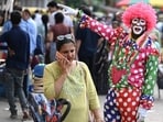 Gram it: Delhi's streets offer a glimpse of the city life. Here's how an artist dressed as a clown to gesture and attract customers, to a shop at a marketplace. 