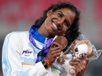 Indian hurdler Vithya Ramraj poses with her bronze medal in Nagoya on Monday,.