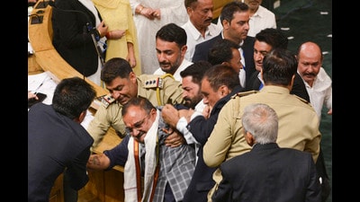 BJP MLAs being restrained during a protest in J&K assembly in Srinagar on Monday. (PTI) BJP MLAs being restrained during a protest in J&K assembly in Srinagar on Monday. (PTI)