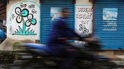 A TMC symbol graffiti drawn on a wall at Kalighat, in Kolkata. (PTI File Photo) A TMC symbol graffiti drawn on a wall at Kalighat, in Kolkata. (PTI File Photo)