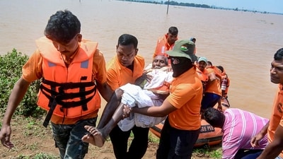 SDRF personnel conduct a rescue operation at a flood-affected area of Surali village in Koraput, Odisha. (PTI)