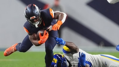Denver Broncos running back RJ Harvey, left, is tripped up by Los Angeles Rams linebacker Byron Young during the first half of an NFL football game Sunday. (AP Photo/David Zalubowski) (AP Photo/David Zalubowski) Denver Broncos running back RJ Harvey, left, is tripped up by Los Angeles Rams linebacker Byron Young during the first half of an NFL football game Sunday. (AP Photo/David Zalubowski) (AP Photo/David Zalubowski)