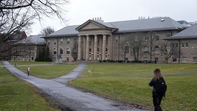 People walk on the campus of Cornell University in Ithaca, N.Y., Friday, Feb. 2, 2024.