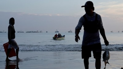 Fishermen unload their catch in Manta, where income from fishing is often just a few hundred dollars a month.