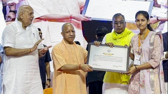 Chief minister Yogi Adityanath at the ceremony where appointment letters were distributed to gram panchayat officers selected through the Uttar Pradesh Subordinate Services Selection Commission, in Lucknow on Monday. (PTI PHOTO)