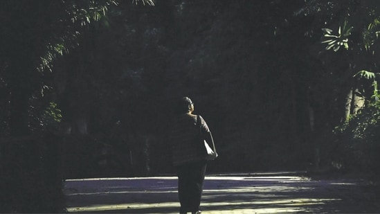 A deserted and poorly lit walking path inside of Qudsia Park. 