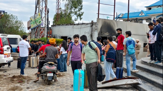Lovely Professional University (LPU) students, carrying their luggage, prepare to leave for their hometowns, in Phagwara on Monday. (PTI)