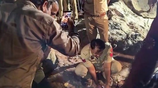 Police personnel and others conduct a rescue operation after a three-year-old girl fell into a nearly 200-foot-deep borewell while playing at Seehi village, in Faridabad, Haryana.