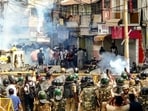Security personnel disperse protesters by firing tear gas shells following stone-pelting incidents during a protest against the proposed removal of a portion of the 'Shahi Masjid' for road widening, in Ujjain 
