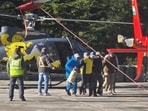 Trekkers, porters landed at Harshil helipad after their evacuation from higher reaches in Uttarkashi district. (HT Photo)