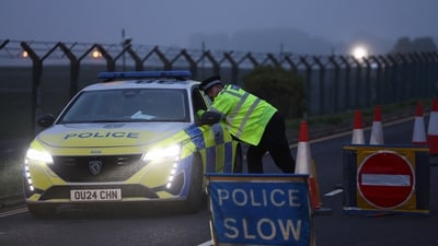 A police officer guards an area as roadblocks remain in place near RAF Fairford airbase. (REUTERS/Toby Shepheard)