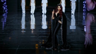 Stepping onto the runway, actor Aishwarya Rai commanded complete attention in a breathtaking creation by Yara Shoemaker. The two-piece velvet gown was adorned with intricate 3D fringe embroidery that swayed with every step. Capping off the regal silhouette was a shimmering, crystal-embellished cape, blending old-world glamour with modern architectural design. (Reuters)