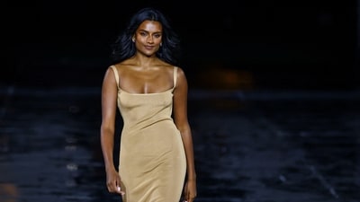 Actor Simone Ashley looked effortlessly elegant in a sleek, nude gown with thin straps and a side slit. She completed the look with metallic heels and soft, voluminous waves. (Reuters)