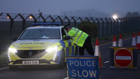 A police officer guards an area as roadblocks remain in place near RAF Fairford airbase. 