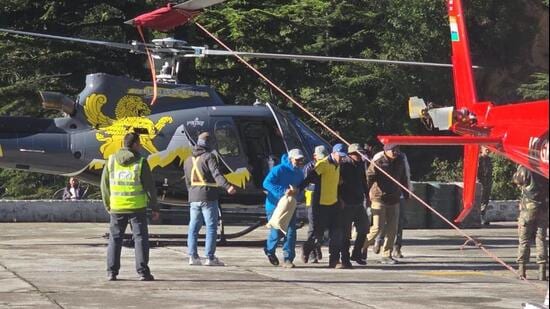 Trekkers, porters landed at Harshil helipad after their evacuation from higher reaches in Uttarkashi district. (HT Photo)