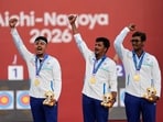 India's Sahil Rajesh Jadhav, center, Kushal Dalal, left, and Ganesh Mani Ratnam Thirumuru, right, pose with the gold medals on the podium after the compound men's team final in archery at the Asian Games in Okazaki