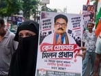 Congress party workers participate in a protest rally against the arrest of Milan Pradhan in Kolkata.