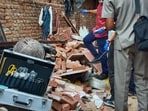 Officials inspect the site after an under-construction floor of a building collapsed in Tahirpur on Tuesday. (HT)