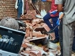 Officials inspect the site after an under-construction floor of a building collapsed in Tahirpur on Tuesday.