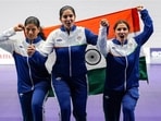 From left, India's Manisha Keer, Ashima Ahlawat and Neeru Dhanda pose with the national flag after winning the silver medal during the victory ceremony for the women's trap shooting team event at the 20th Asian Games 2026