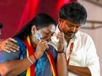 Tamil Nadu CM C Joseph Vijay comforts TVK’s Dharapuram bypoll candidate P Sathyabama at the rally in Tiruppur district on Wednesday. (PTI)