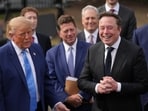 President Donald Trump listens as Elon Musk speaks to reporters at the White House in Washington on Tuesday.
