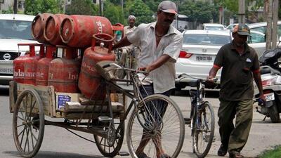 A-delivery-man-carrying-LPG-cylinders-at-Kitchlu-Nagar-in-Ludhiana-on-Wednesday-JS-Grewal-HT