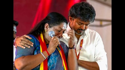 Tamil Nadu CM C Joseph Vijay comforts TVK’s Dharapuram bypoll candidate P Sathyabama at the rally in Tiruppur district on Wednesday. (PTI) Tamil Nadu CM C Joseph Vijay comforts TVK’s Dharapuram bypoll candidate P Sathyabama at the rally in Tiruppur district on Wednesday. (PTI)