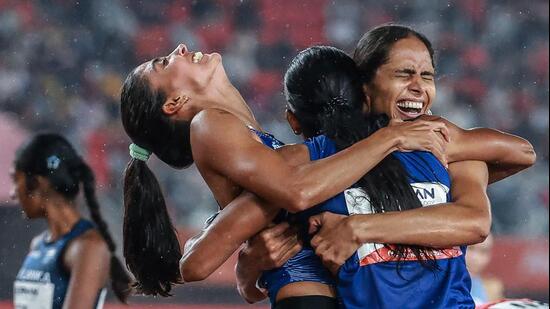 India's Prachi, India's Kiran and India's Poovamma Machettira celebrate winning the women's 4x400m relay final during the 2026 Asian Games. (AFP)