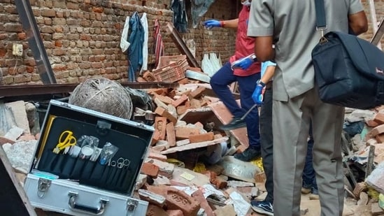 Officials inspect the site after an under-construction floor of a building collapsed in Tahirpur on Tuesday. (HT Photo)