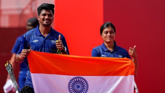 India's Sahil Jadhav, left, and Chikitha Taniparthi celebrate after winning the compound mixed team archery gold medal match against Korea during the 20th Asian Games