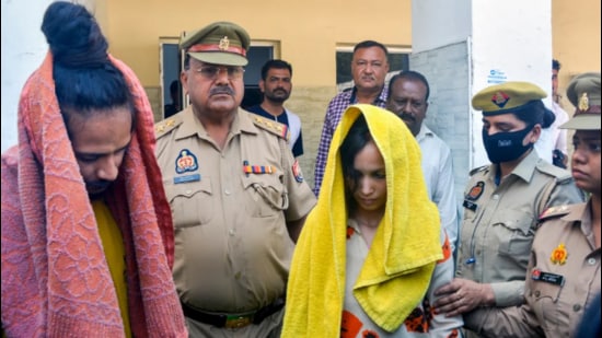 Police take away Merchant Navy officer Saurabh Rajput’s wife Muskan and her lover Sahil Shukla after they were arrested in connection with his murder. (PTI file Photo)