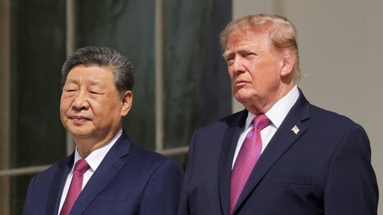 US President Donald Trump and Chinese President Xi Jinping watch a military demonstration from a balcony of the White House in Washington on September 24. 