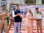 Chief minister Yogi Adityanath receives a memento from director general of police Rajeev Krishna during the flagging off of interceptor vehicles (four-wheelers and two-wheelers) equipped with state-of-the-art equipment, in Lucknow on Thursday. (ANI PHOTO)