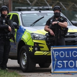 Police officers guard an area as roadblocks remain in place near RAF Fairford airbase.