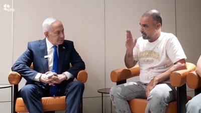 Israeli Prime Minister Benjamin Netanyahu meets Yaniv Hayun, a passenger on the FlyDubai flight bound for Israel from the United Arab Emirates, which was diverted to Saudi Arabia following an emergency signal (via REUTERS)