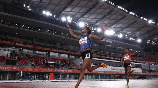 India's Vithya Ramraj celebrates as she crosses the finish line to win the women's 4 x 400m Relay Final. (REUTERS)