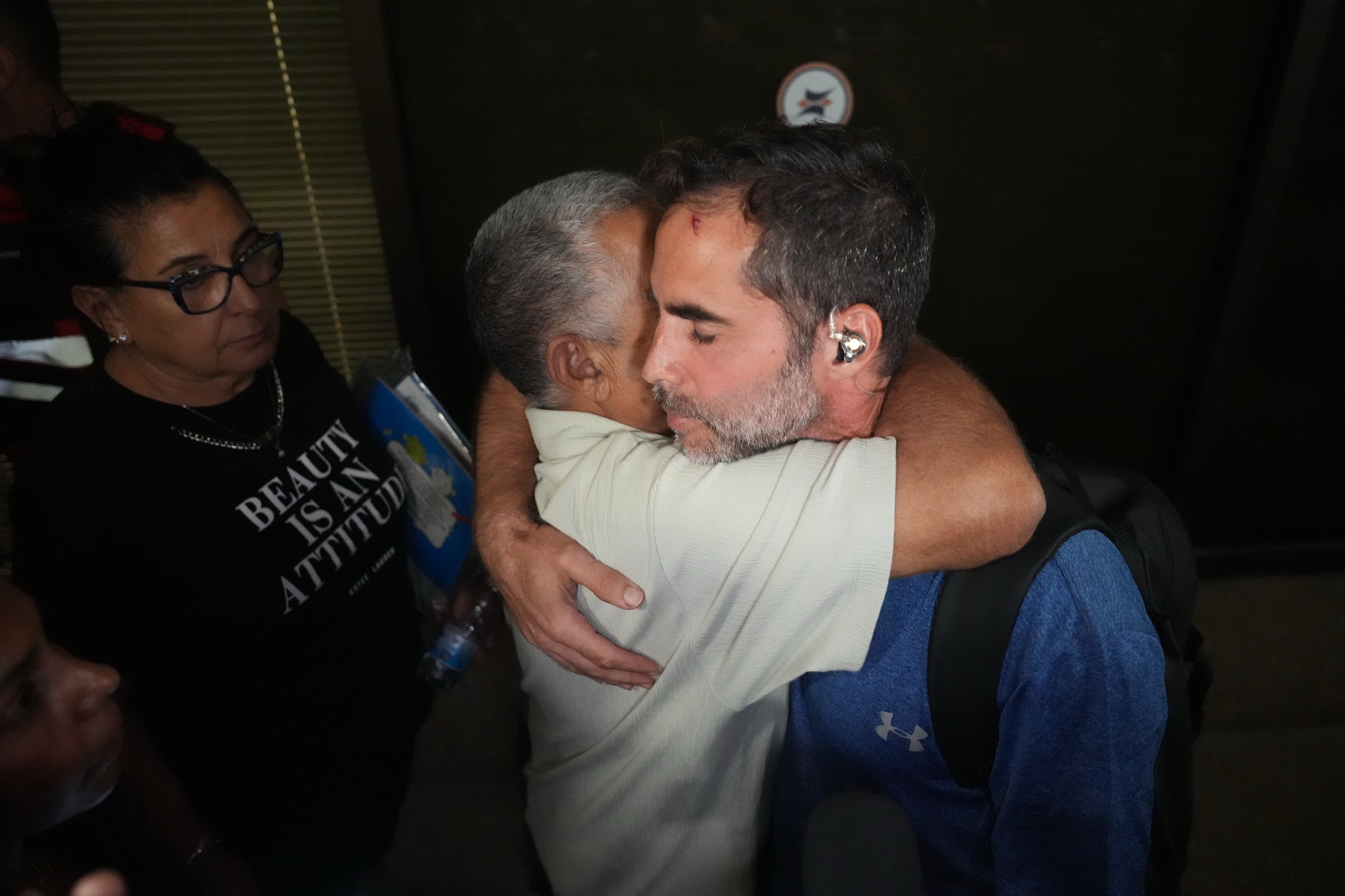 Israeli passenger Asaf Rajuan, right, who experienced an emergency landing in Saudi Arabia, during a flight on a flydubai plane, hugs another passenger from the same flight as they arrive at Ben Gurion International Airport, near Tel Aviv, Israel, Wednesday (AP) Israeli passenger Asaf Rajuan, right, who experienced an emergency landing in Saudi Arabia, during a flight on a flydubai plane, hugs another passenger from the same flight as they arrive at Ben Gurion International Airport, near Tel Aviv, Israel, Wednesday (AP)