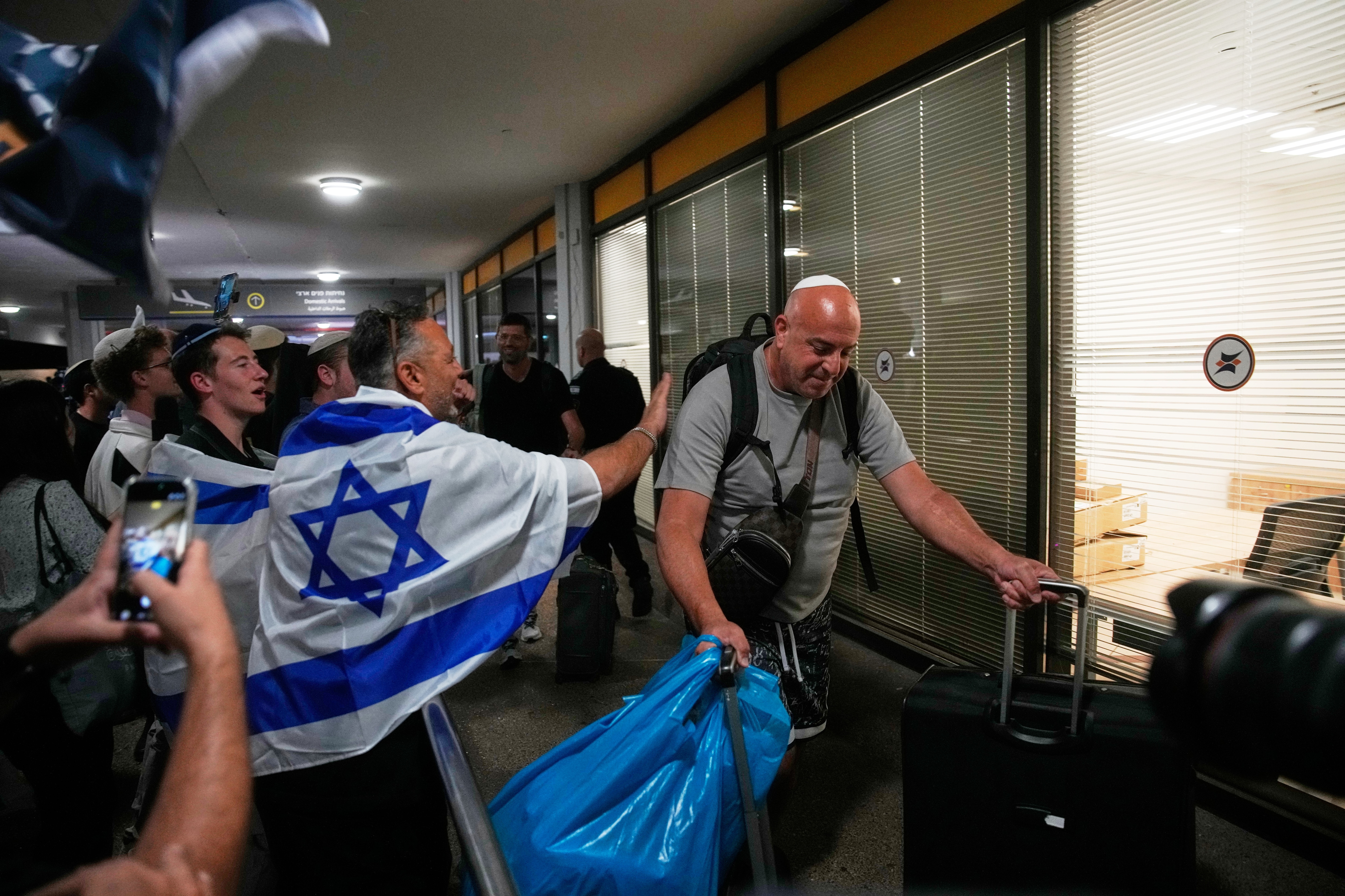 Israeli passengers who had been aboard a FlyDubai aircraft that made an emergency landing in Saudi Arabia are welcomed at the arrivals gate at Ben Gurion International Airport near Tel Aviv. (AP) Israeli passengers who had been aboard a FlyDubai aircraft that made an emergency landing in Saudi Arabia are welcomed at the arrivals gate at Ben Gurion International Airport near Tel Aviv. (AP)