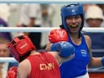 India's Lovlina Borgohain, in blue, and China's Bao Ziyi, in red, fight in their women's 75kg boxing final match at the Asian Games in Nishio, Aichi prefecture, Japan, Friday, Oct. 2, 2026. (AP Photo/Lee Jin-man) (AP Photo/Lee Jin-man)