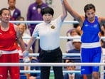 India's Lovlina Borgohain, in blue, celebrates after winning gold medal.