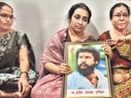 Vijeta Purnekar, widow of the deceased Pradeep Punekar, grieves at their home in Thane, holding a photograph of her husband, who was shot dead. (Praful Gangurde / Hindustan Times)