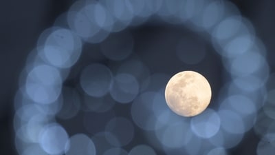 The Cold Moon is pictured behind Christmas decorations in Cali, Colombia on December 3, 2025. (Photo by JOAQUIN SARMIENTO / AFP) (AFP) The Cold Moon is pictured behind Christmas decorations in Cali, Colombia on December 3, 2025. (Photo by JOAQUIN SARMIENTO / AFP) (AFP)